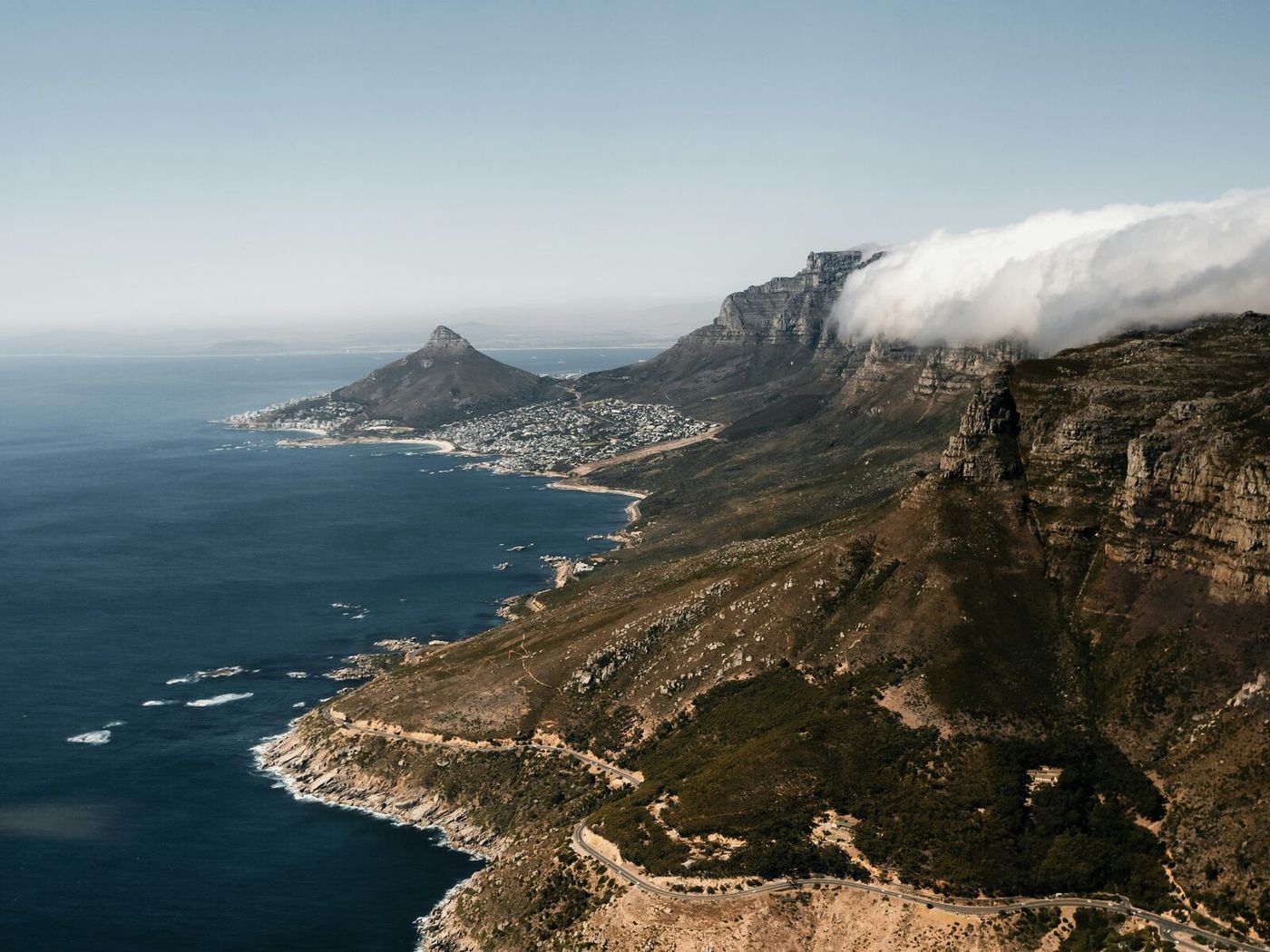 Cape Town under Table Mountain in clear daylight, the city and coastline below.